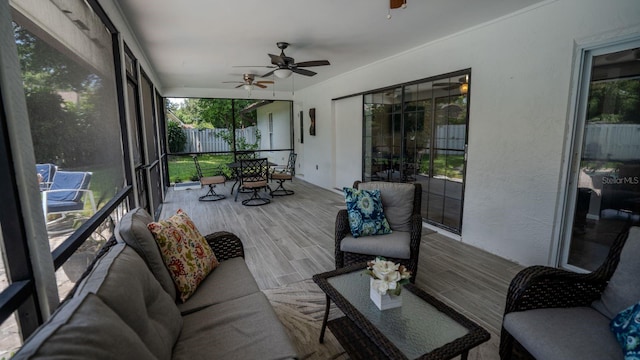 sunroom with ceiling fan