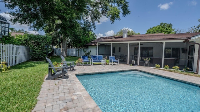 view of swimming pool featuring a yard, a patio, and ceiling fan