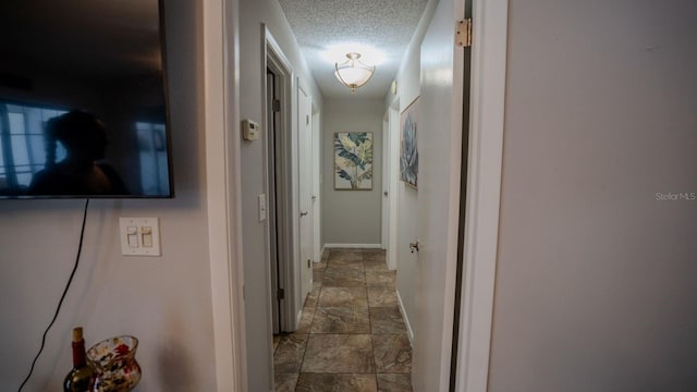 corridor with a textured ceiling