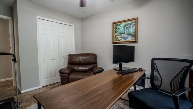 office featuring ceiling fan and a textured ceiling