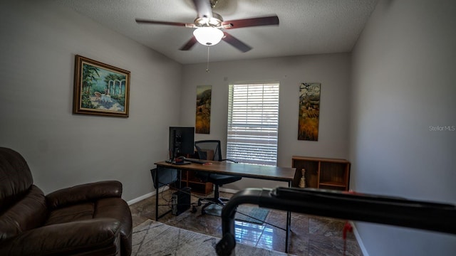 office space featuring a textured ceiling and ceiling fan