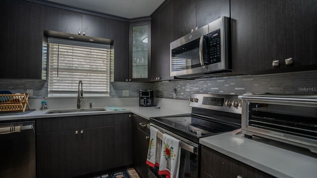 kitchen with decorative backsplash, appliances with stainless steel finishes, and sink