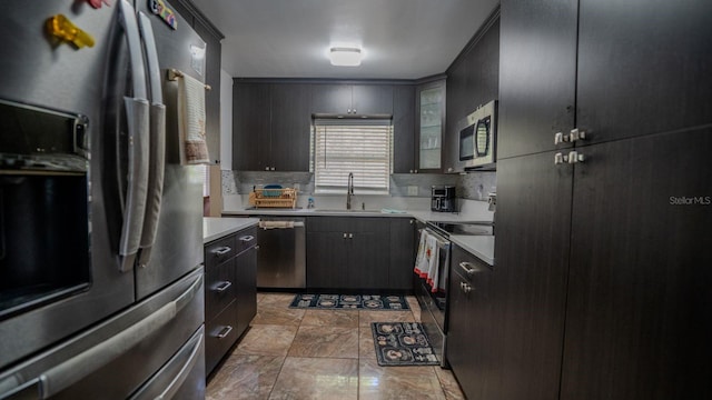 kitchen featuring decorative backsplash, sink, and appliances with stainless steel finishes