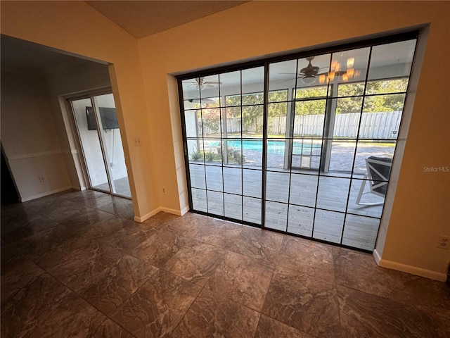 interior space with ceiling fan and lofted ceiling