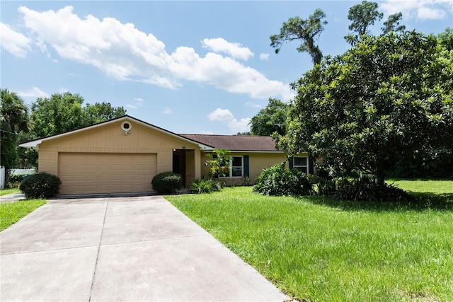 ranch-style home featuring a garage and a front lawn