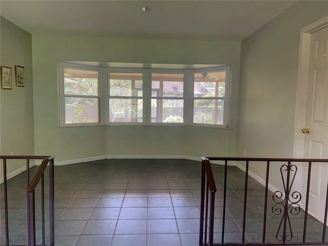 tiled empty room featuring a wealth of natural light