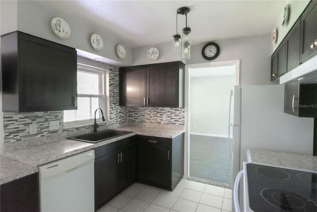 kitchen with dishwasher, decorative light fixtures, tasteful backsplash, sink, and light tile patterned floors