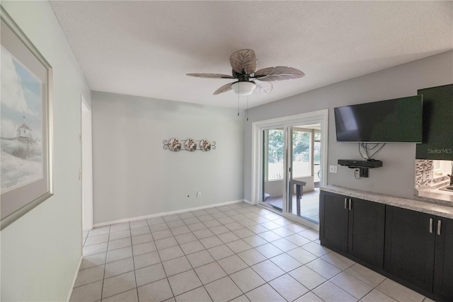 interior space with ceiling fan and light tile patterned floors