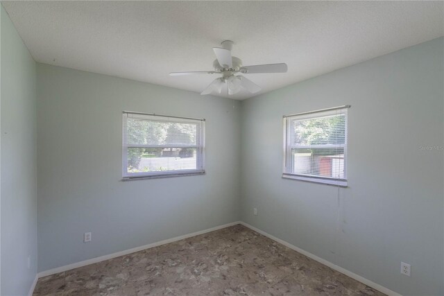 tiled empty room with ceiling fan