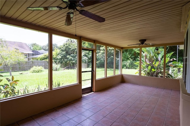 unfurnished sunroom with ceiling fan