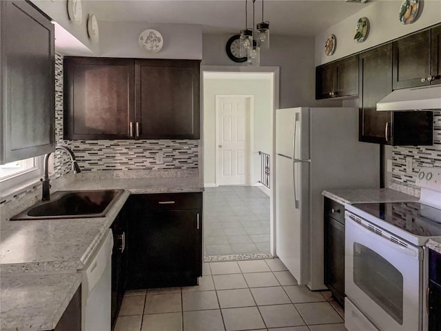 kitchen with backsplash, pendant lighting, light tile patterned flooring, white appliances, and dark brown cabinets