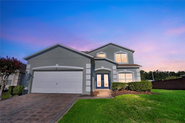 view of front of home featuring a lawn and a garage