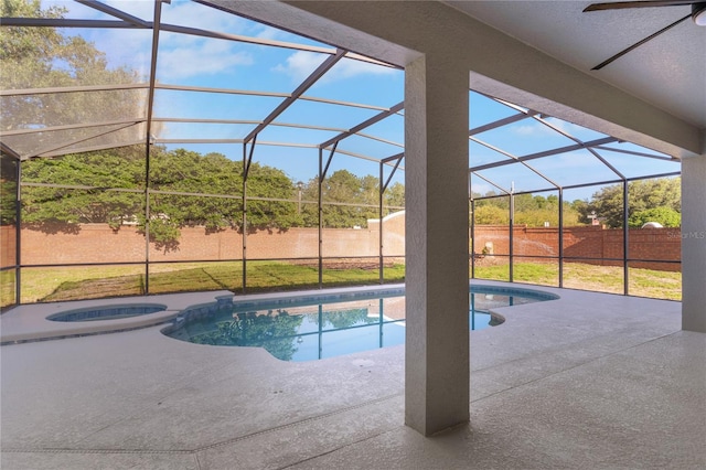 view of swimming pool featuring glass enclosure, a lawn, and a patio