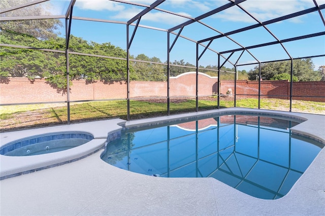 view of pool featuring glass enclosure and an in ground hot tub