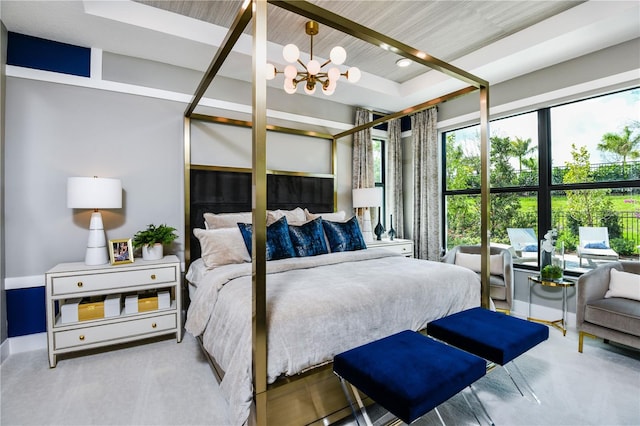 bedroom featuring a raised ceiling and an inviting chandelier