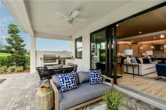 view of patio / terrace with ceiling fan, outdoor lounge area, area for grilling, and an outdoor kitchen