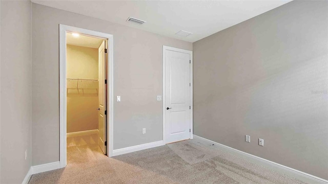 4910 Carova Way, Lakewood Ranch, FL 34211 - unfurnished bedroom with visible vents, baseboards, a closet, a spacious closet, and carpet