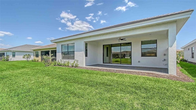 4910 Carova Way, Lakewood Ranch, FL 34211 - rear view of property featuring a lawn, a patio, a ceiling fan, and stucco siding