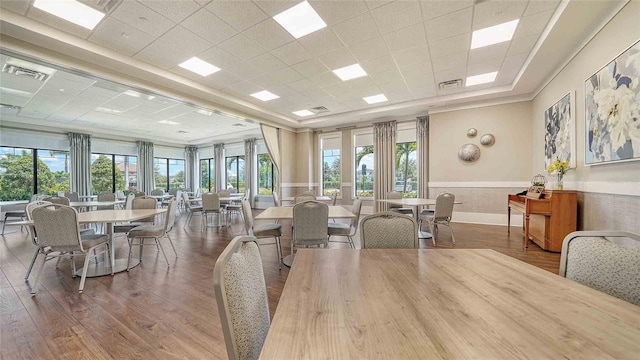 4910 Carova Way, Lakewood Ranch, FL 34211 - dining space with wood finished floors, a drop ceiling, visible vents, and a healthy amount of sunlight