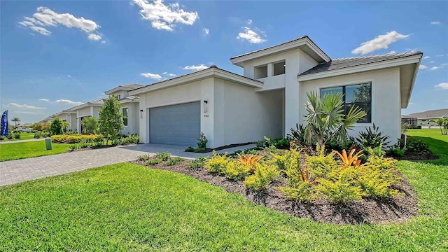 4910 Carova Way, Lakewood Ranch, FL 34211 - view of front of house with an attached garage, stucco siding, driveway, and a front yard