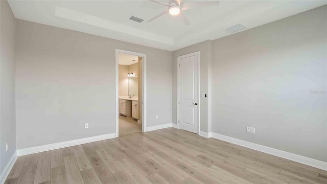 4910 Carova Way, Lakewood Ranch, FL 34211 - unfurnished bedroom featuring ceiling fan, light wood-style floors, baseboards, ensuite bathroom, and visible vents