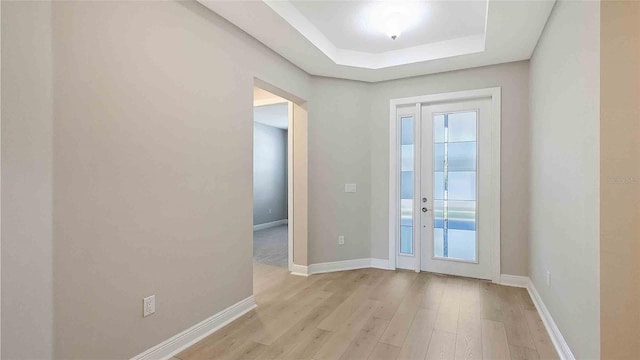 4910 Carova Way, Lakewood Ranch, FL 34211 - entryway with a raised ceiling, light wood-style flooring, and a wealth of natural light