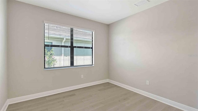 4910 Carova Way, Lakewood Ranch, FL 34211 - unfurnished room featuring baseboards, light wood-type flooring, and visible vents
