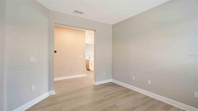 4910 Carova Way, Lakewood Ranch, FL 34211 - empty room featuring visible vents, light wood finished floors, and baseboards