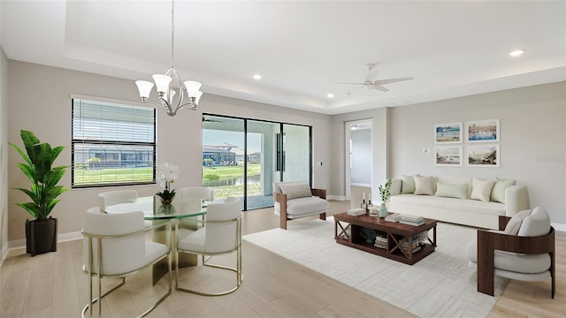 4910 Carova Way, Lakewood Ranch, FL 34211 - living area with recessed lighting, light wood-style flooring, baseboards, and a tray ceiling