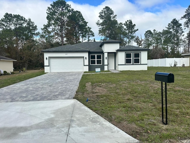 view of front facade featuring a garage and a front lawn