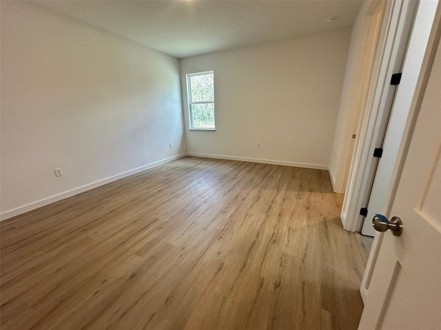 spare room with light wood-type flooring