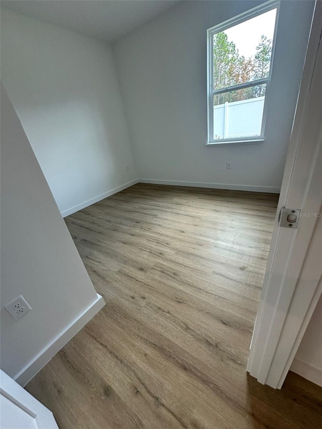 spare room with light hardwood / wood-style flooring