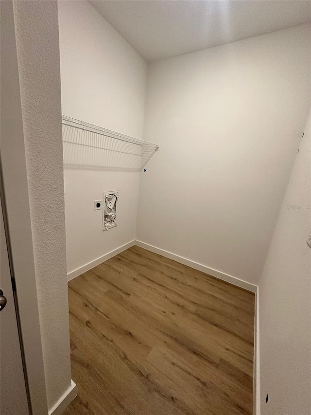 laundry room with hardwood / wood-style floors and hookup for an electric dryer