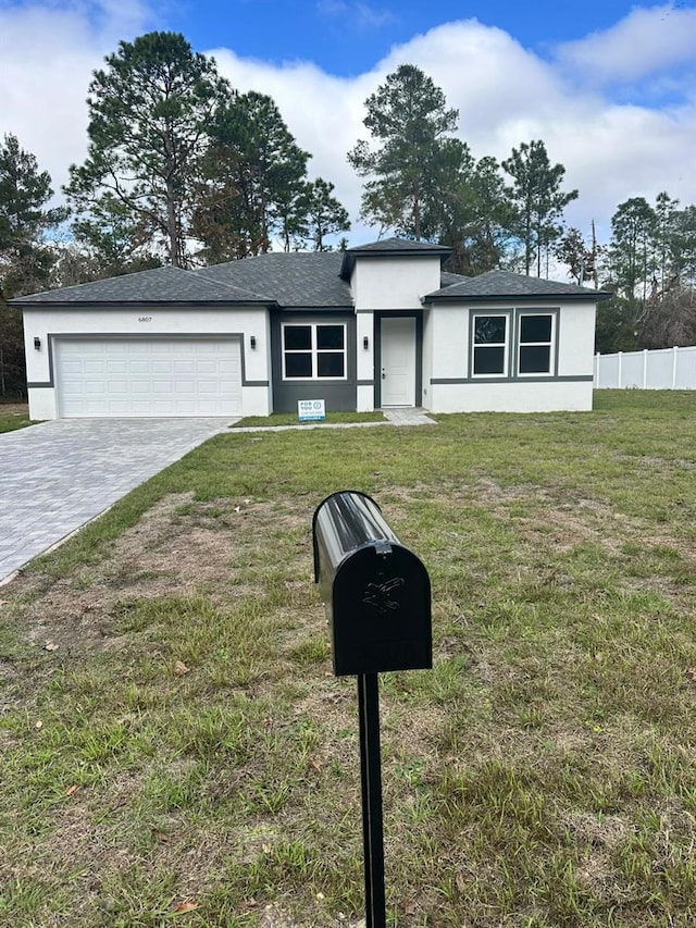 view of front facade with a garage and a front lawn