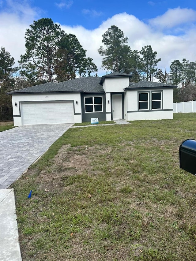 view of front of property featuring a garage and a front yard