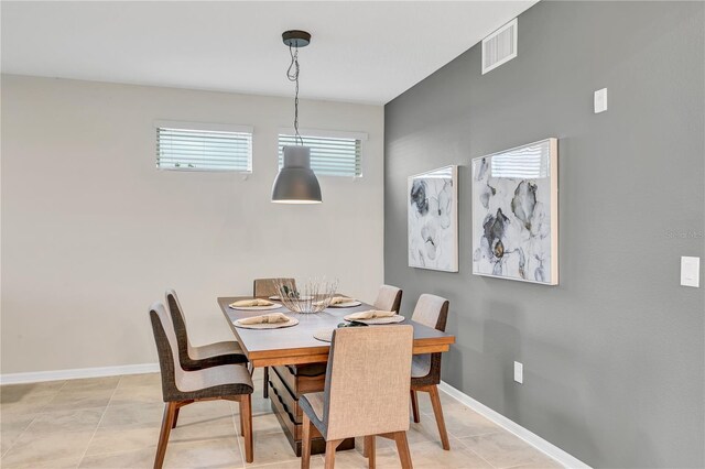 dining room featuring baseboards, visible vents, and light tile patterned floors