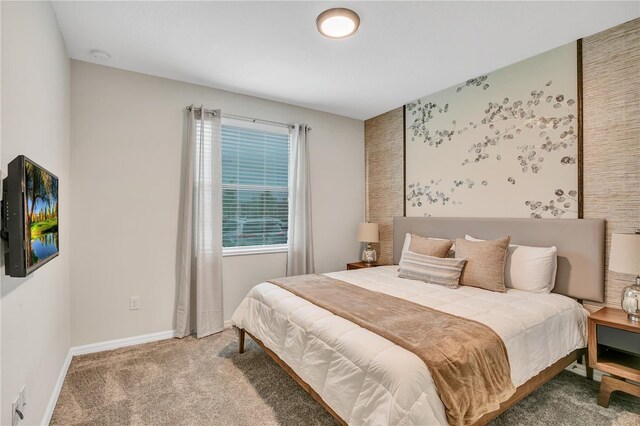 bedroom with carpet flooring and baseboards