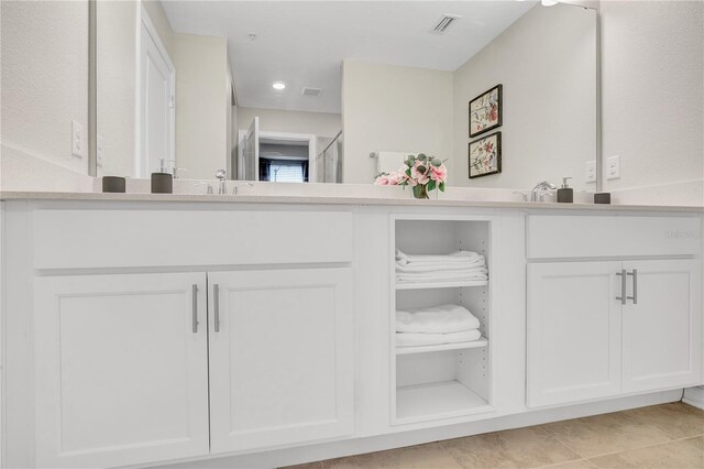 bathroom with tile patterned flooring, vanity, visible vents, and recessed lighting