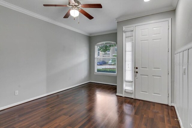 foyer entrance with ceiling fan, dark wood-type flooring, and ornamental molding