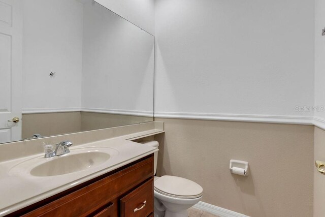 bathroom with tile patterned floors, toilet, and vanity