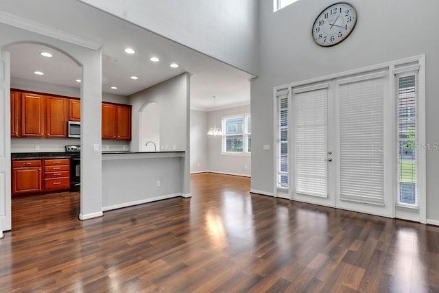 foyer featuring baseboards, ornamental molding, dark wood-type flooring, and recessed lighting