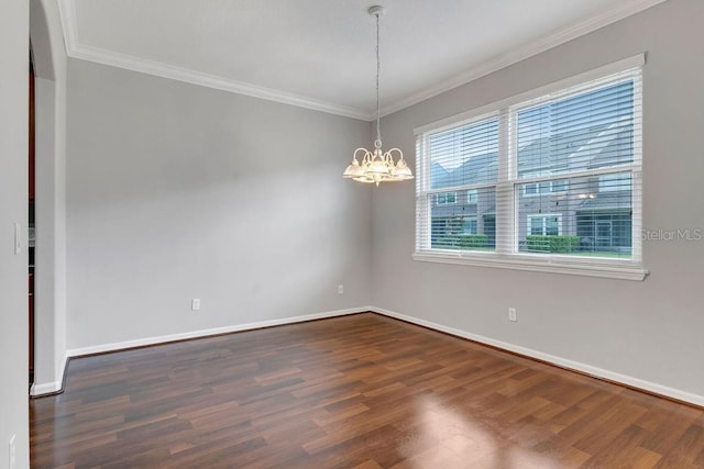 empty room with a notable chandelier, crown molding, baseboards, and dark wood-type flooring