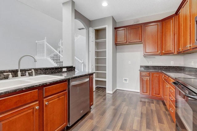 kitchen featuring dark wood-style floors, electric range, a sink, dark stone counters, and dishwasher