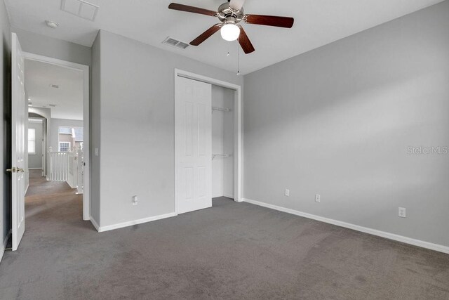 unfurnished bedroom with ceiling fan, a closet, and carpet flooring