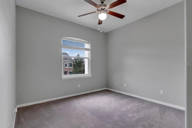 spare room featuring carpet, baseboards, and ceiling fan