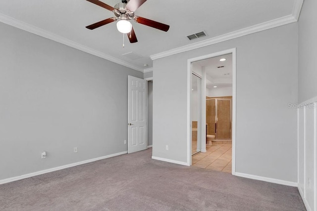 unfurnished bedroom with connected bathroom, light carpet, visible vents, baseboards, and crown molding