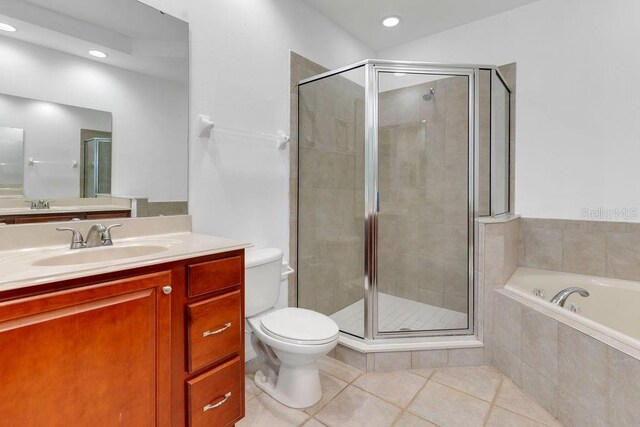 full bathroom with tile patterned flooring, separate shower and tub, vanity, and toilet