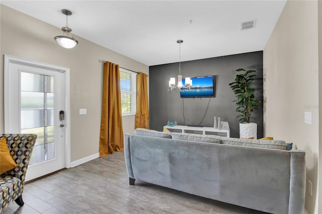 living room featuring a chandelier and wood-type flooring