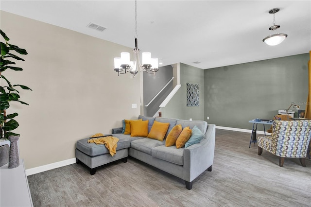 living room featuring hardwood / wood-style flooring and an inviting chandelier