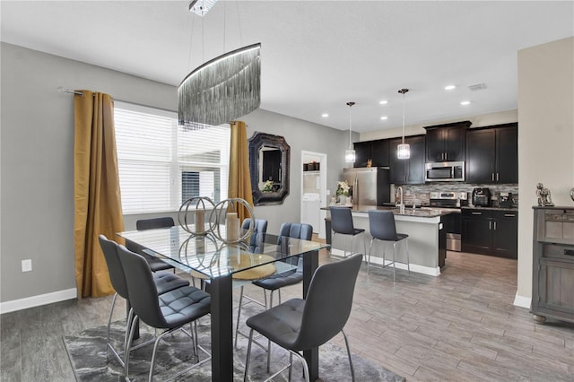 dining room with sink and light hardwood / wood-style flooring